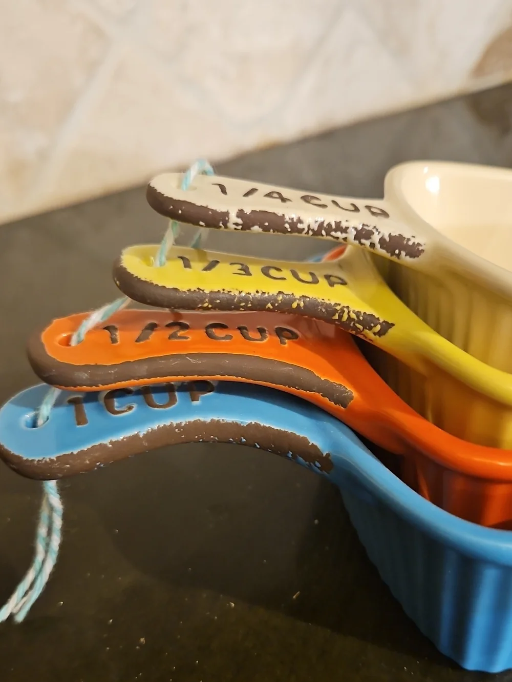 Creative Co-Op Ceramic Triangle Measuring Cups in Blue, Orange, Yellow, Cream